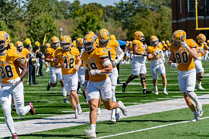 Football players running on the field