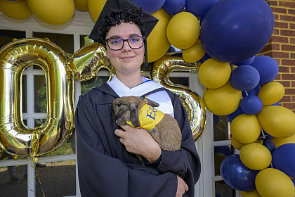Graduate holding rabbit