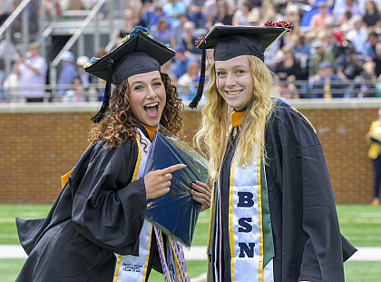 Gradautes pose for a picture