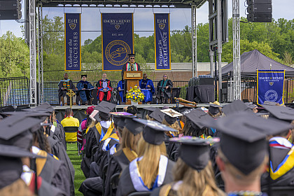 Graduate speaking on stage