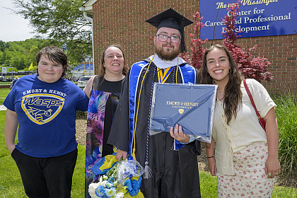Graduate poses with family