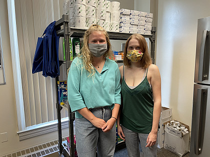 Students volunteer their time to organize the shelves at the Stinger's Supply Shelf.