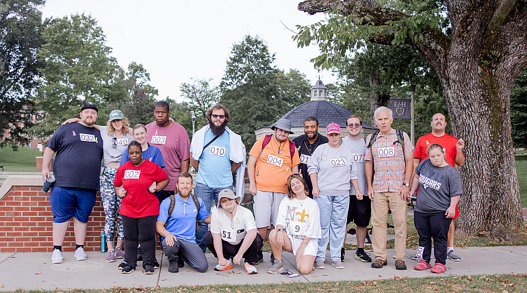 A group of Color Run participants pose for a picture by the Duck Pond