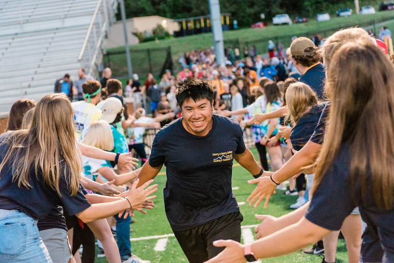 Student participating in a campus ice breaker activity.