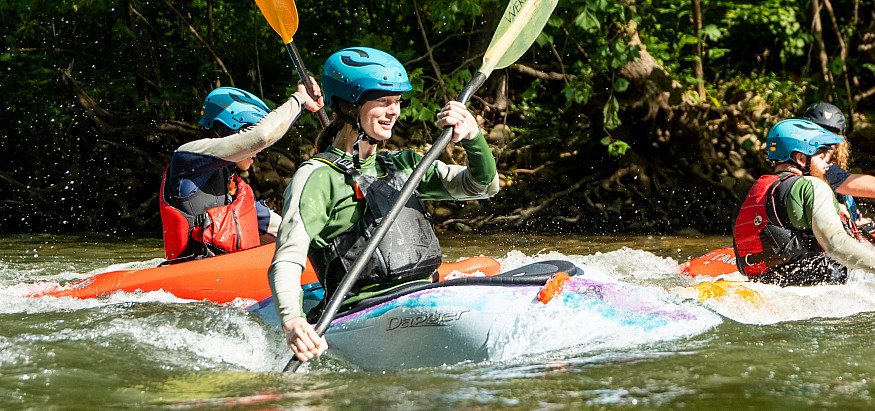 Student kayaking on the river
