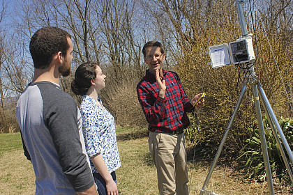 Professor teaching a class of students outside