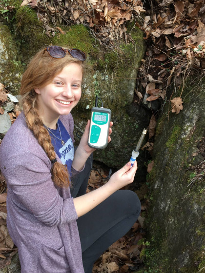 Student measuring stream pH