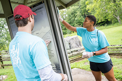 Student working on outdoor sign