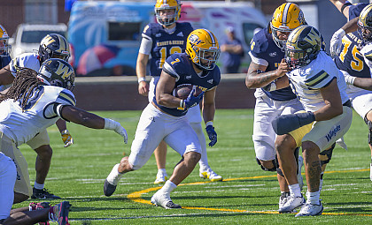 E&H football player running with football