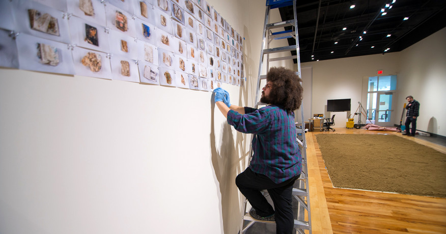 Students work to help install a show at the MCA Art Gallery 