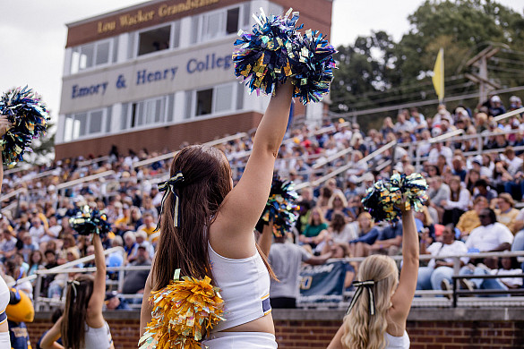 Cheerleaders perform for an audience in the bleachers
